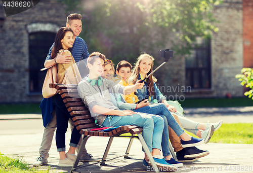 Image of happy teenage students taking selfie by smartphone