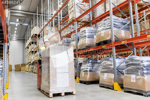 Image of loader operating forklift at warehouse