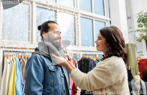 Image of couple choosing clothes at vintage clothing store