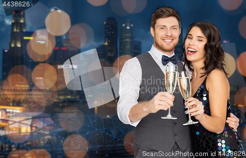 Image of happy couple with champagne glasses at party