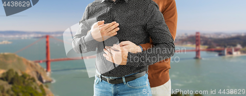 Image of close up of hugging gay couple in san francisco