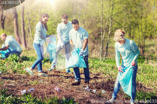 Image of volunteers with garbage bags cleaning park area