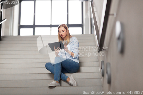 Image of woman or student with tablet pc sitting on stairs