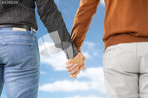 Image of close up of male gay couple holding hands