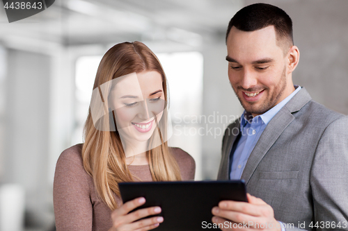 Image of businesswoman and businessman with tablet pc
