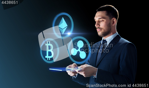 Image of businessman with tablet pc and cryptocurrency