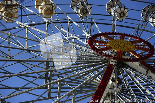 Image of ferris wheel in amusement park on blue sky 