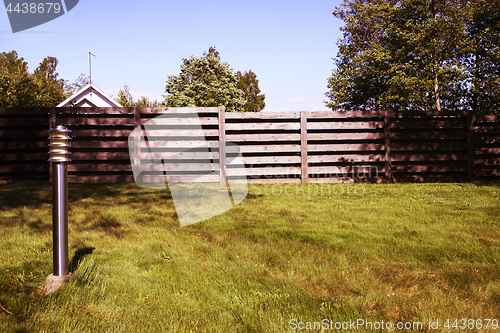 Image of lantern, green lawn and fence, photo filter