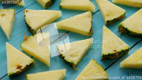 Image of Pineapple pieces on blue desk 