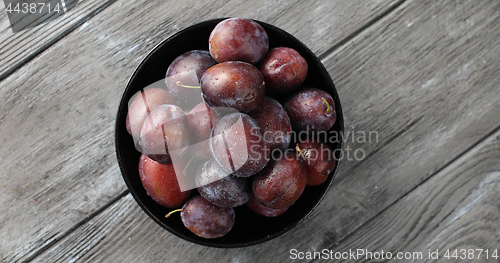 Image of Bowl of wet ripe plums