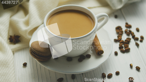 Image of Cup of coffee with cookie and cinnamon