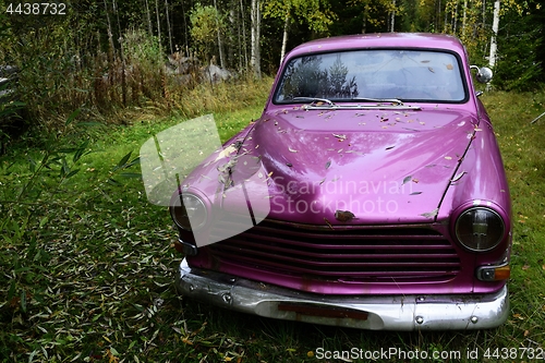 Image of abandoned crimson old car