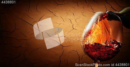 Image of Wine on cracked clay background