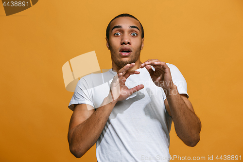 Image of Portrait of the scared man on orange