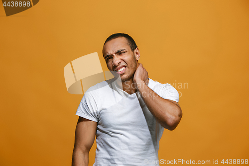 Image of Young man overwhelmed with a pain in the neck