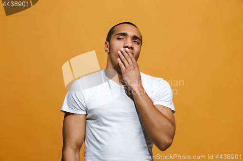 Image of Beautiful bored man bored isolated on orange background