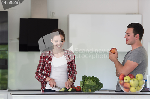 Image of Young handsome couple in the kitchen