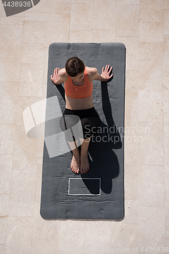 Image of woman doing morning yoga exercises top view