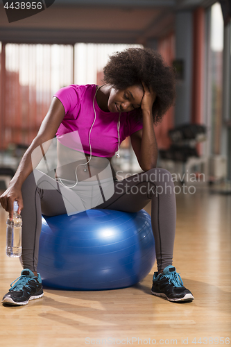 Image of woman  relaxing after pilates workout