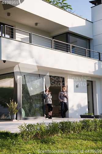 Image of couple enjoying on the door of their luxury home villa