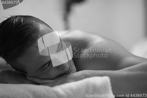 Image of handsome man resting in a spa massage center