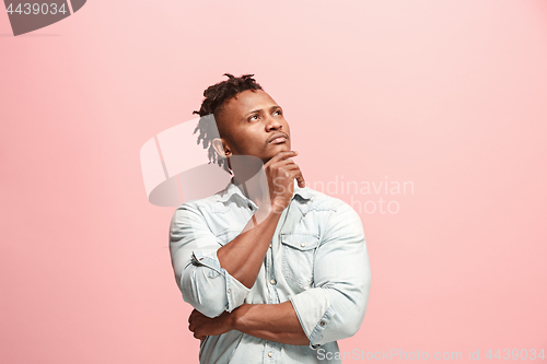 Image of Young serious thoughtful Afro-American businessman. Doubt concept.