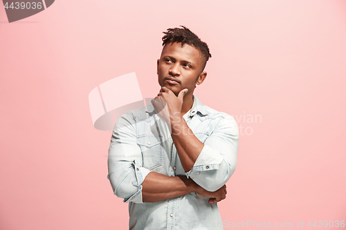 Image of Young serious thoughtful Afro-American businessman. Doubt concept.