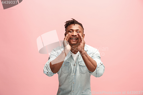 Image of Isolated on pink young Afro-American man shouting at studio