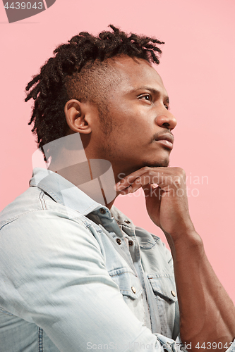 Image of Young serious thoughtful Afro-American businessman. Doubt concept. Profile view