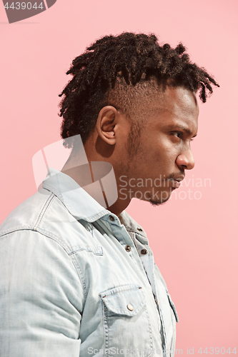 Image of The young emotional angry afro man on pink studio background