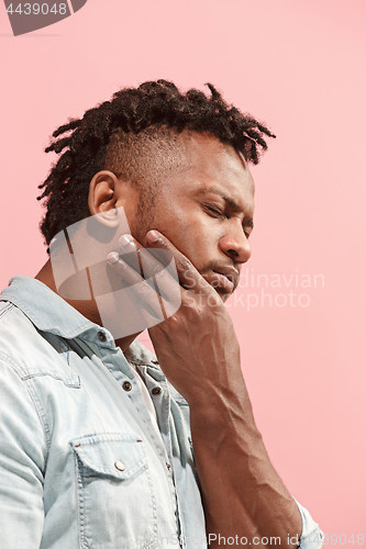 Image of Young Afro-American man is having toothache.