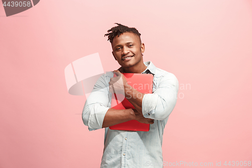 Image of Afro-American Businessman hugging laptop