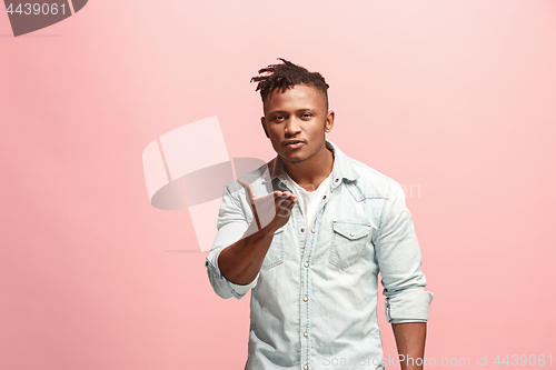 Image of Portrait of attractive Afro-American man with air kiss isolated over pink background