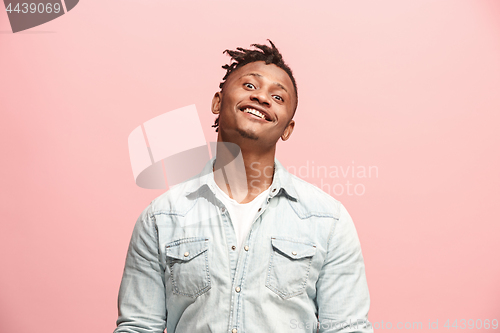 Image of The happy business man standing and smiling against pink background.
