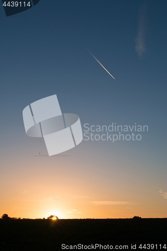 Image of Sunrise and Plane Trail