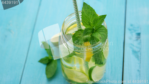 Image of Refreshing lemonade on blue table 