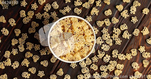 Image of Bowl of pasta on wooden table