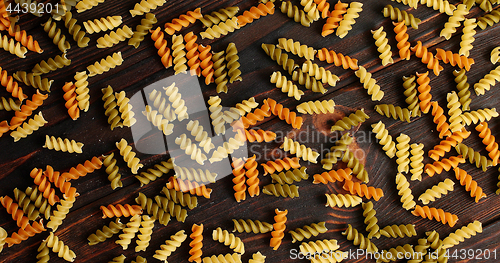 Image of Messy arrangement of pasta on wood