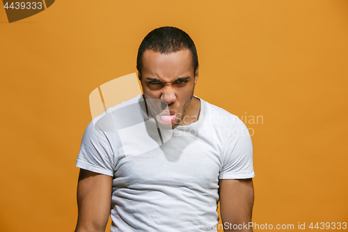 Image of The young emotional angry and scared man standing and looking at camera