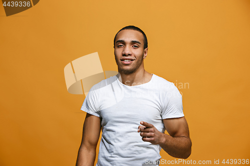 Image of The happy business man point you and want you, half length closeup portrait on pink background.