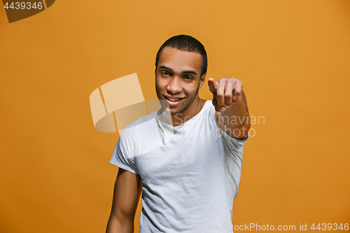 Image of The happy business man point you and want you, half length closeup portrait on pink background.