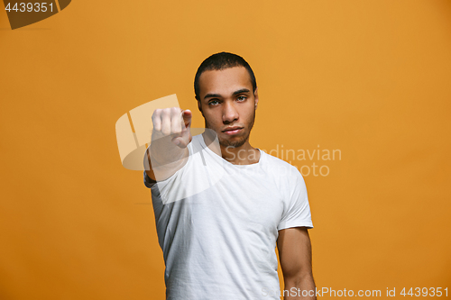 Image of The overbearing businessman point you and want you, half length closeup portrait on orange background.