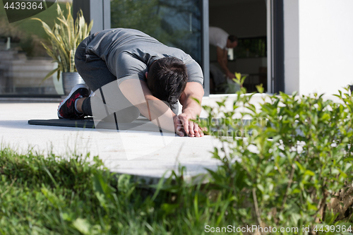 Image of man doing morning yoga exercises