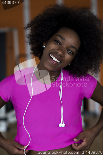 Image of afro american woman running on a treadmill