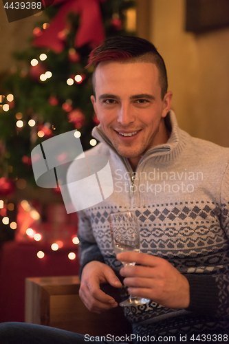 Image of Happy young man with a glass of champagne