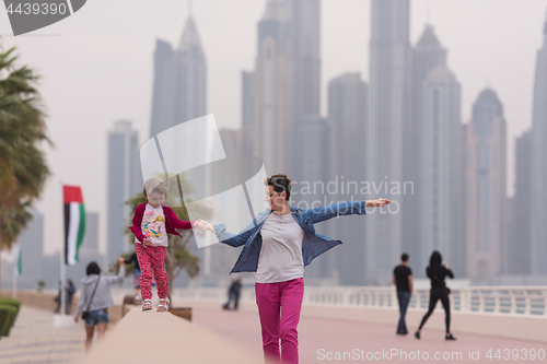 Image of mother and cute little girl on the promenade