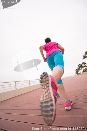 Image of woman busy running on the promenade