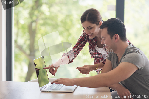 Image of happy young couple buying online