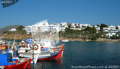 Image of greek fishing boats in piso livadi harbor with cyclades architec