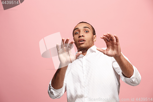 Image of Portrait of the scared man on pink